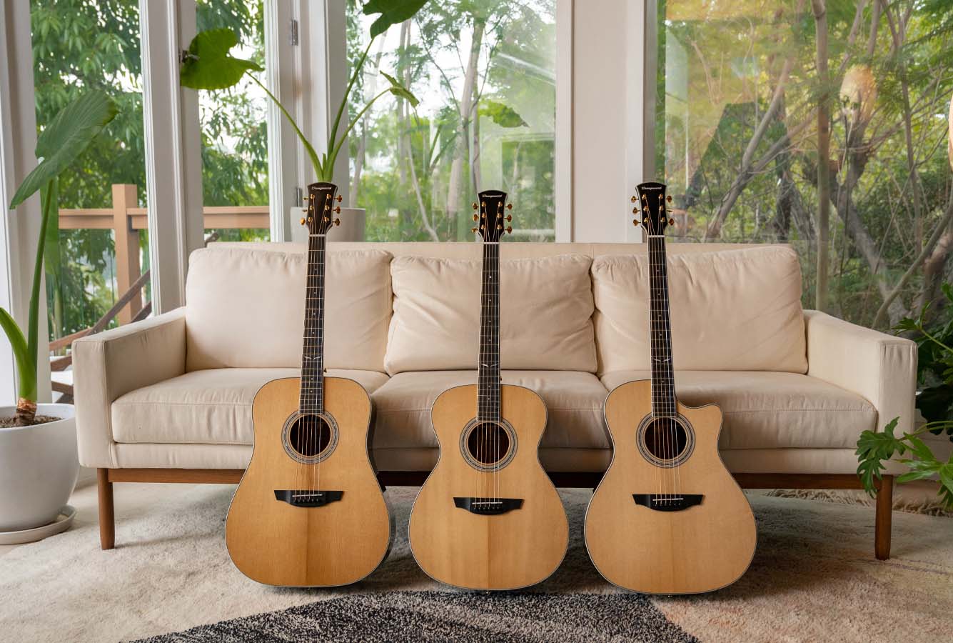 Berkeley, Sierra, and Cleo guitars sitting in front of a white sofa