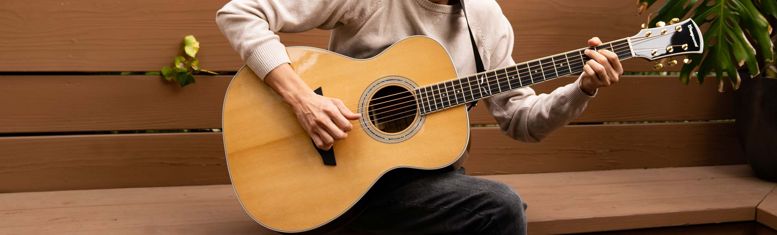 The Brooklyn Torrefied Spruce guitar played on a yellow sofa.