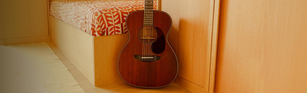 The Echo guitar played on a yellow sofa.