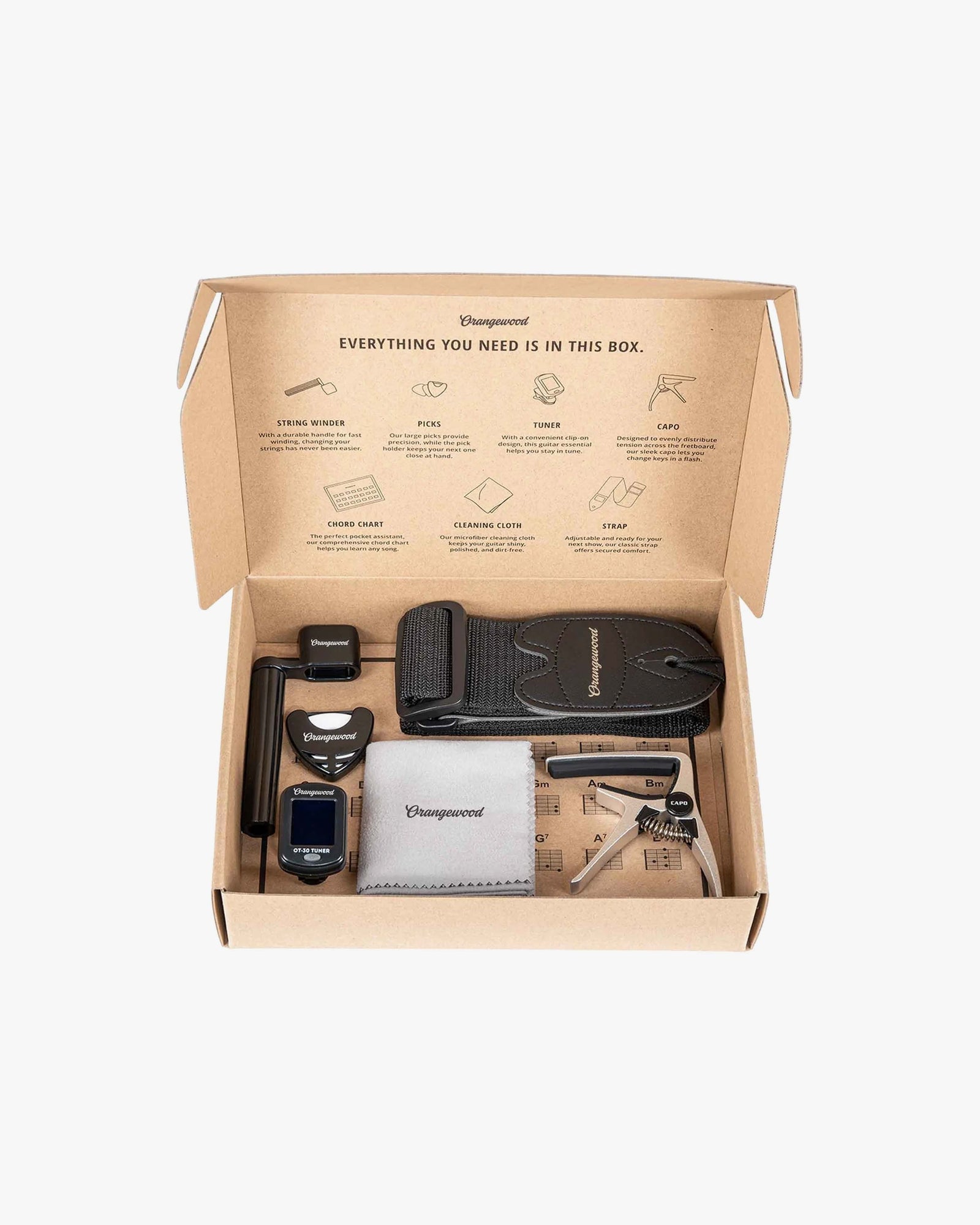 Accessory kit box with tuner, string winder, microfiber cloth, strap, and capo