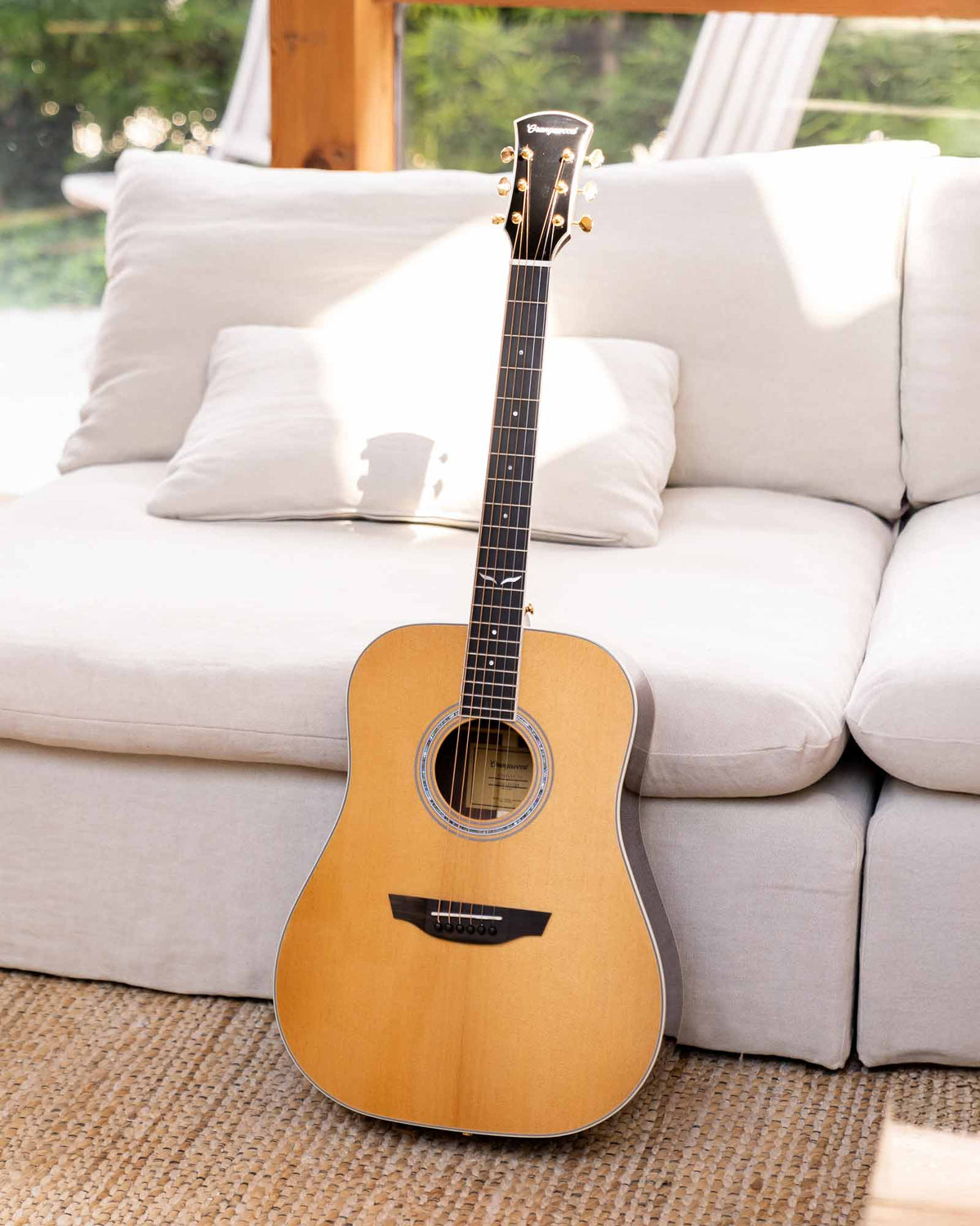 berkeley guitar in front of a white sofa