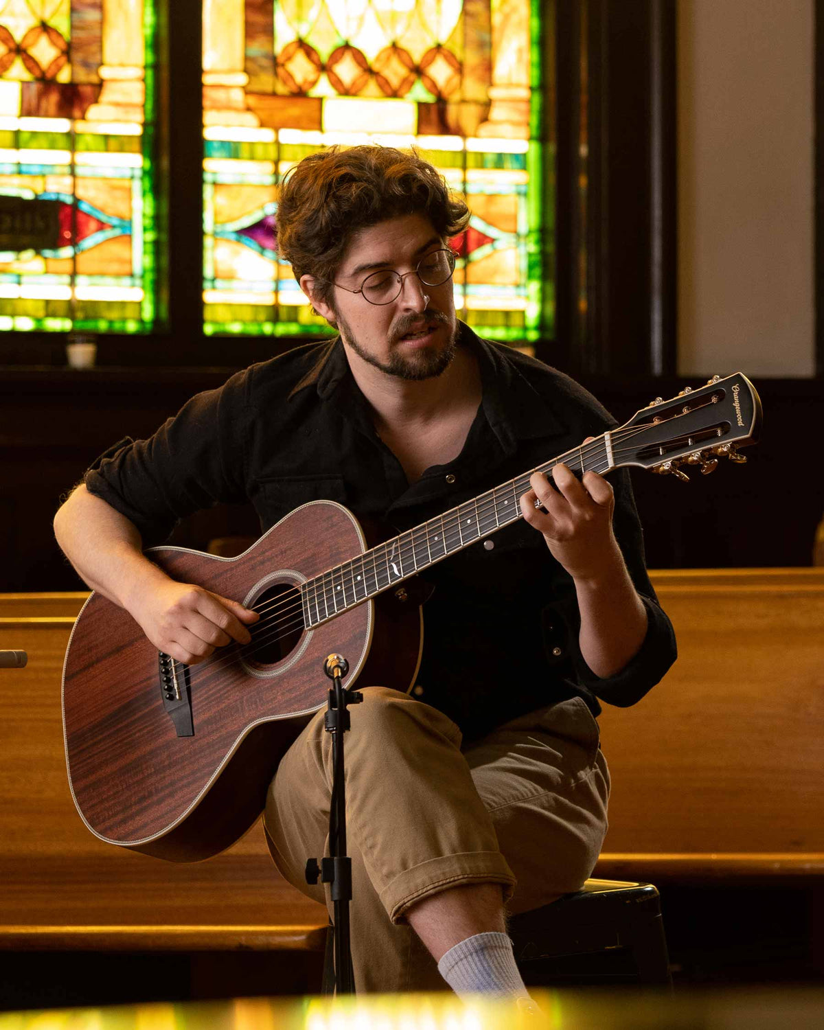 Artist playing the julian mahogany guitar