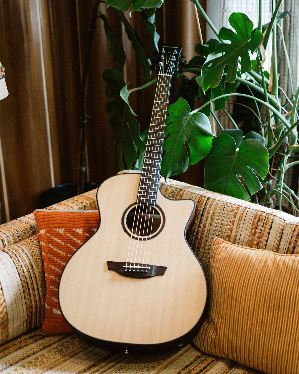 Morgan spruce guitar on a sofa