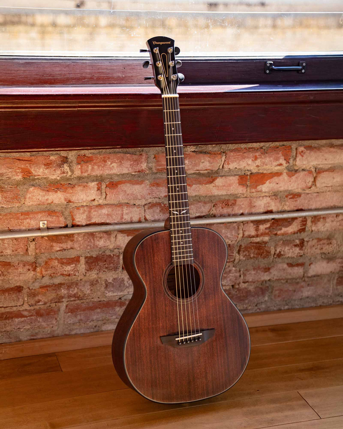 Oliver jr. guitar against a brick wall