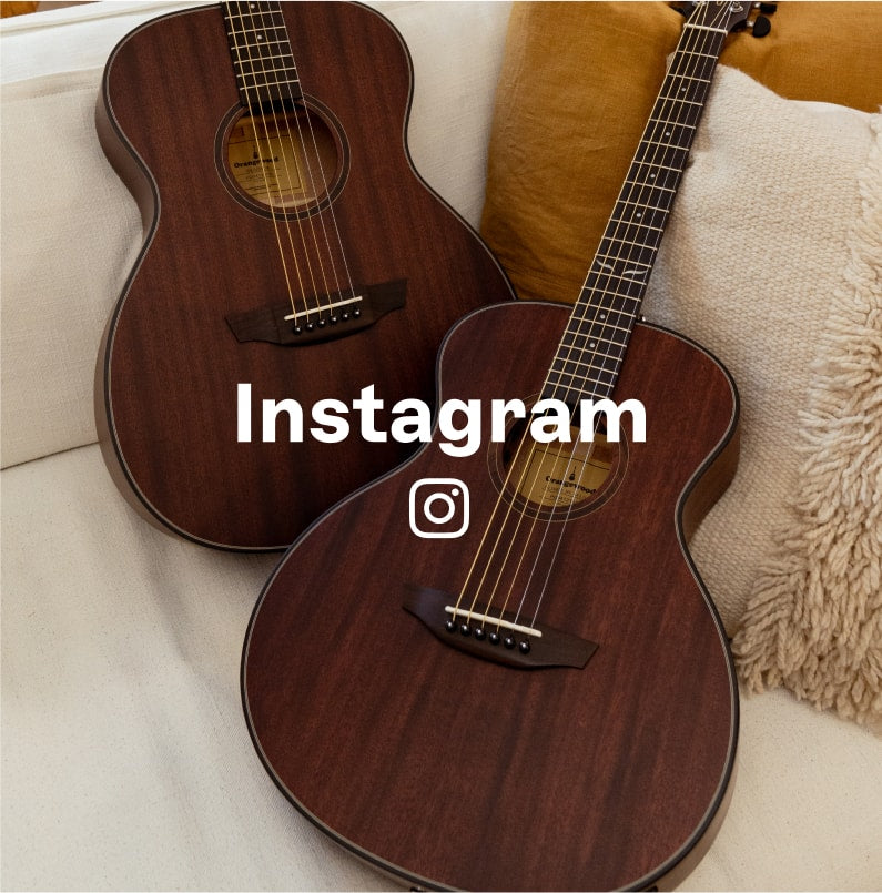Two guitars on a sofa with instagram logo