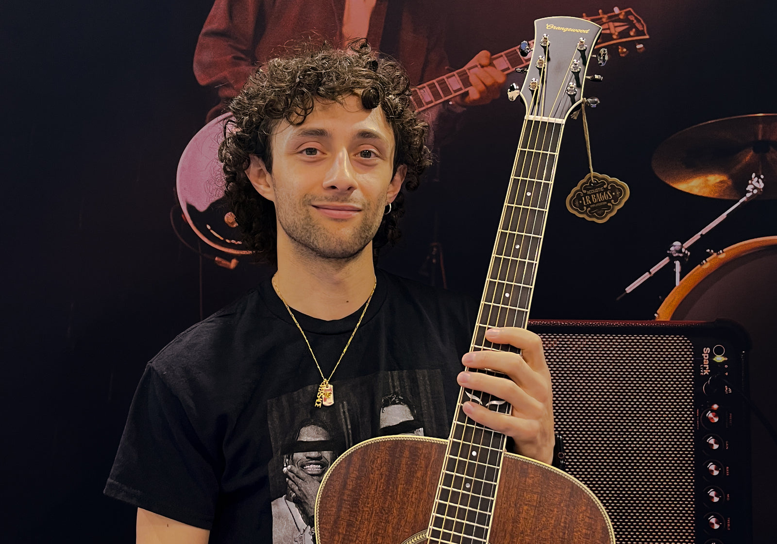 Dre DiMura holding an orangewood guitar