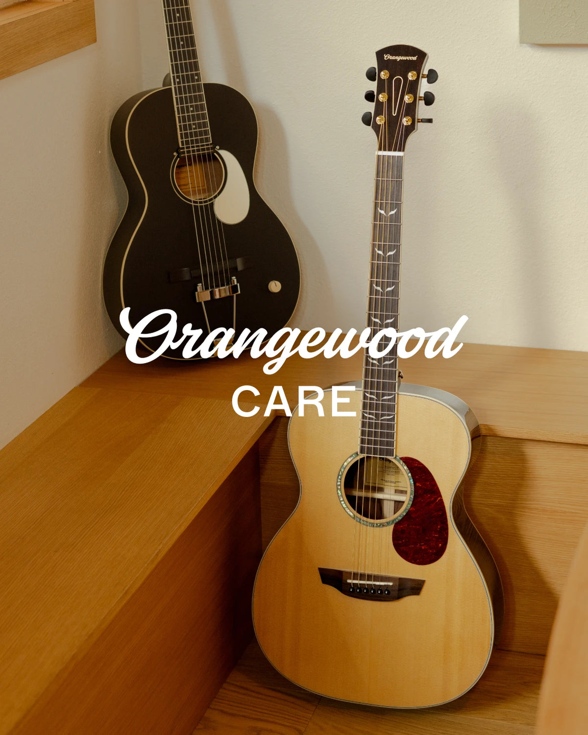Orangewood Care: black rubber bridge guitar and natural acoustic guitar in a corner